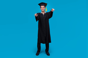 Young University Asian Man Graduate in Mortarboard and Gown, Pointing to Camera Choosing You