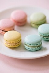 Obraz premium arafed macarons on a plate on a pink table