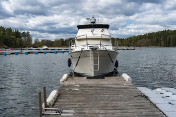 Yacht boat marina port near old wooden pier. Yacht mooring. Jetty. View of the boat. Horizon. Baltic Sea. Speed boats Yachting Equipment.