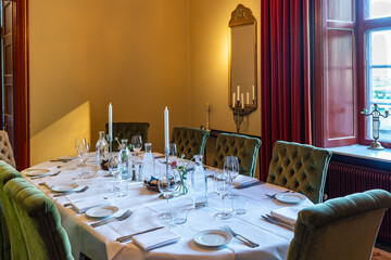 Beautiful full table setting for a banquet dinner. Social reception party celebration dinner service restaurant.