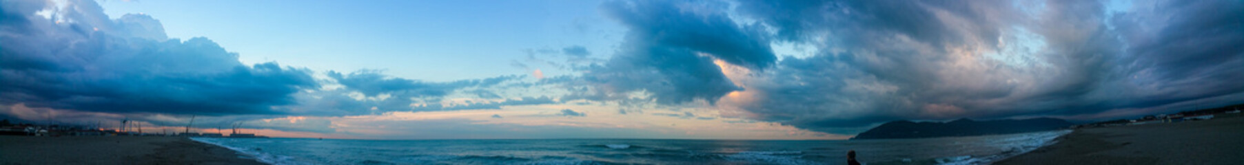 A somewhat blurry picture captures a cloudy sky looming over a serene lake, Carrara, Italy
