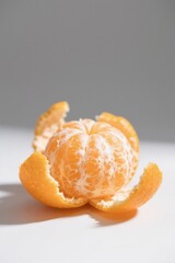 there is a peeled orange sitting on a white surface