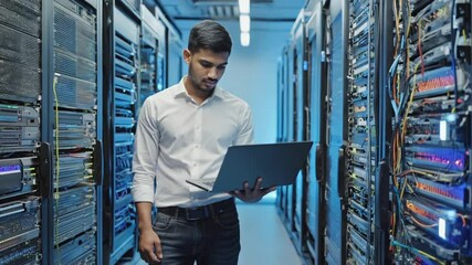 Technician Inspecting Server Racks with Laptop in Data Center - Powered by Adobe
