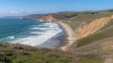 Ocean waves shimmer with light as they slowly wash ashore in an expansive coastal view