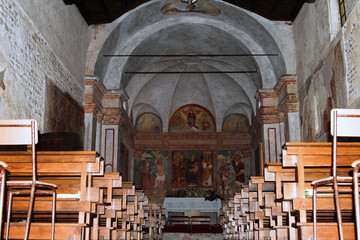 A beautiful church with wooden benches and a vibrant red carpet