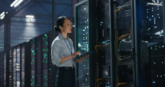 Data Center Female IT Specialist Using Tablet in Server Room. Artificial Intelligence Computing Facility with Asian Maintenance Administrator Working on Computer. Information Technology Professional - Powered by Adobe