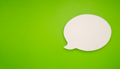 Blank white speech bubble on a vibrant green background.