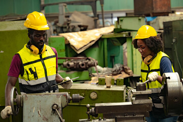 African black man professional technician engineer people workers in heavy industry training control operate CNC machine to young women