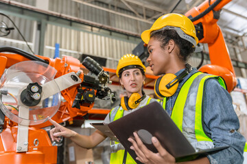 robotic engineer training, technician work in modern factory industrial robot welding arm machine control operator