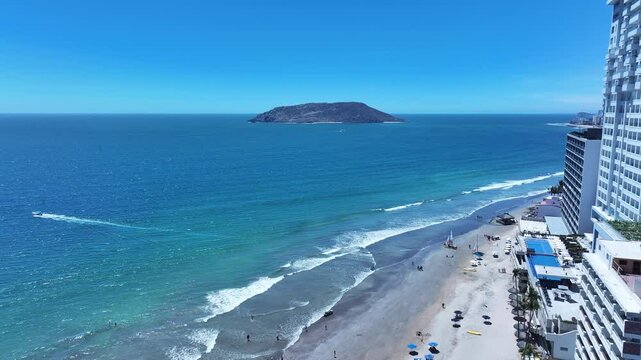  Aerial Mexico Mazatlan city sandy beac. Commercial ocean vacation tourism seaport, cargo and cruise ships. Luxury resort Mexican Riviera. Romantic destination. Sand, surf and beach recreation travel.