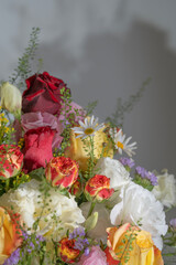 A beautiful arrangement of colorful roses and daisies