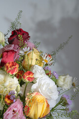A beautiful arrangement of colorful roses and daisies