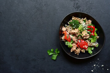 Whole grain pasta salad with tuna and vegetables. Top view with copy space.