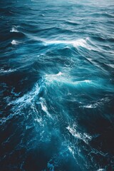 Aerial view of deep blue ocean waves with white foam crests in motion nature seascape