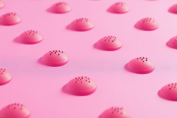 Pink, round objects with dark dots