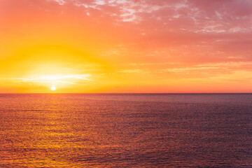 beautiful sunrise or sunset seascape with amazing calm sea water with waves and colorful amazing cloudy morning sky on background