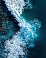 Fototapeta premium Aerial view of ocean wave crashing on reef; turquoise water with white foam; drone photography; tropical paradise