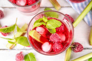 Raspberry rhubarb iced tea, lemonade or mojito. Cold summer fruit refreshment drink with rhubarb...