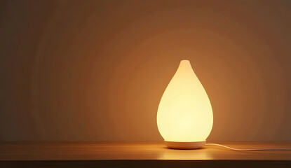 Warm-Lit Teardrop Shaped LED Table Lamp on Wooden Surface
