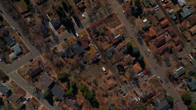 Birdseye aerial drone view perspective downtown Golden Colorado neighborhood buildings streets homes winter sunny daytime Denver front range Morrison Boulder upwards motion