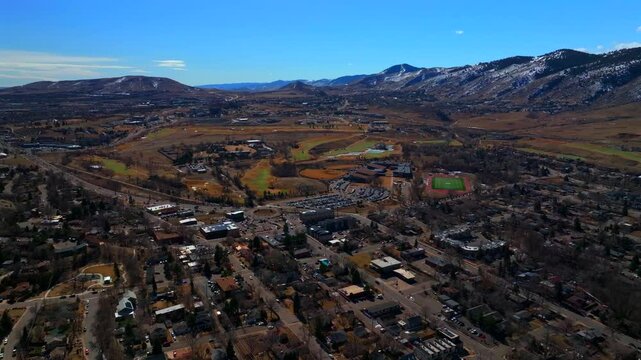 Snowy Lookout Mountain Morrison Golden High School Colorado aerial drone Colorado Fossil Trace Golf Club Jefferson County historic downtown winter sunny morning afternoon blue sky homes forward pan up