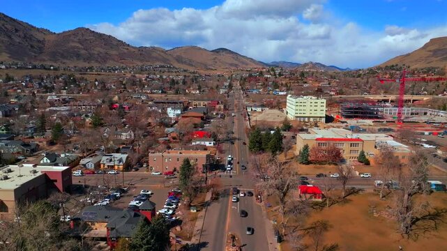 Golden Colorado aerial drone Historic downtown Golden Gate Canyon winter sunny morning afternoon blue sky Highway 93 Boulder Flat Irons Clear Creek River Canyon crane buildings cars forward motion