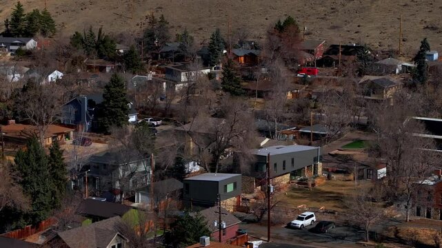 Historic Golden Colorado aerial drone neighborhood homes condominiums buildings Colorado School of Mines cars streets trees telephone lines North Table Mountain slow pan to the left motion