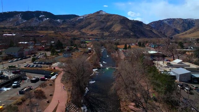 Downtown Golden Colorado aerial drone Clear Creek River trail waterpark Golden Gate Canyon Grange bridge winter sunny snow fishing North Table Mountain Coors Factory upstream forward motion