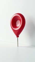 Single, intensely red pin against stark white , vibrant, pure, symbol