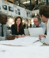 Fototapeta premium Professional people working in a modern business environment, generating ideas, collaborating, and staying productive in a creative and goal-driven workplace.