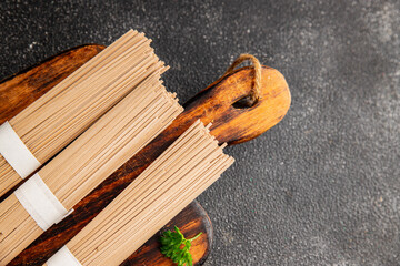 Soba buckwheat noodles raw  fresh dish food Asian cuisine on the table rustic food top view copy space