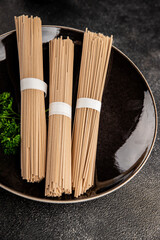 Soba buckwheat noodles raw  fresh dish food Asian cuisine on the table rustic food top view copy space