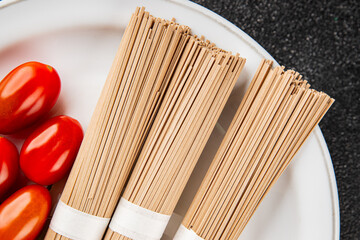 Soba buckwheat noodles raw  fresh dish food Asian cuisine on the table rustic food top view copy space