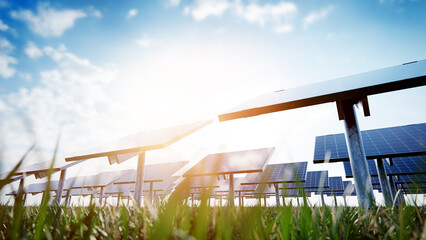 Rows of solar panels are capturing sunlight in a green field under a blue sky, promoting renewable energy and sustainability
