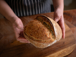 Artisan Sourdough Bread in Hand – Fresh from the Oven.