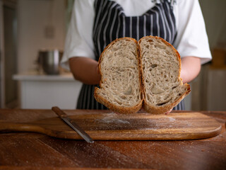 Artisan Sourdough Bread in Hand – Fresh from the Oven.