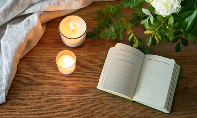 Mental wellness journal and scented candle on wooden table – relaxing mood and self-care concept in cozy setting