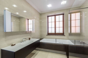 Bathroom with stylish interior design. Dark furniture, window with blinds.