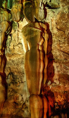 A close-up view of a limestone cave, filled with colorful,curious,wonderful. Lighting enhance...
