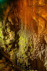 A close-up view of a limestone cave, filled with colorful,curious,wonderful. Lighting enhance texture and geological beauty.