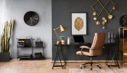 modern home office with dark grey wall black desk gold accents and leather chair