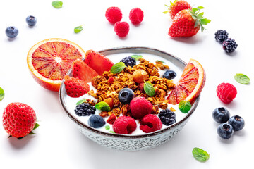 Granola with yogurt and fresh fruit. Organic gourmet muesli with ingredients in a bowl on a white background