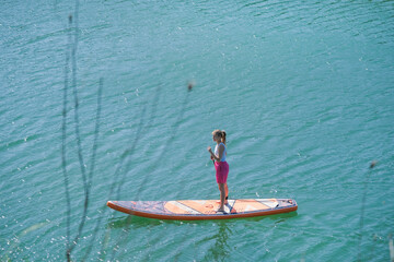 Fototapeta premium woman rowing sup board river water , paddleboard and surfing