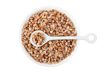 Boiled buckwheat in a ceramic bowl isolated on white background. Top view. Flat lay