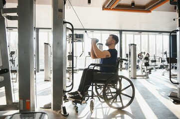 Man with disability lifting weights in a modern gym for rehabilitation and sports training