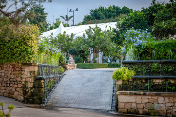 Cascades and flowering trees in the Limestone Heritage Park and Gardens, Siggiewi, Malta.