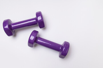 Dumbbells for fitness, sports on light gray background top view flat lay. Concept of healthy lifestyle, wellness, sports equipment for beautiful figure