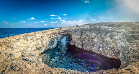 Coral Lagoon with natural arch formation in Northern Malta, Mellieha. Panorama.