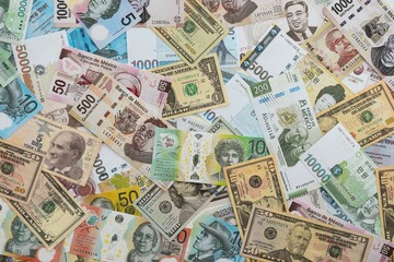 Big amount of money bills of different currencies and countries. Assortment background