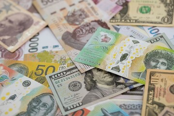 Big amount of money bills of different currencies and countries. Assortment background